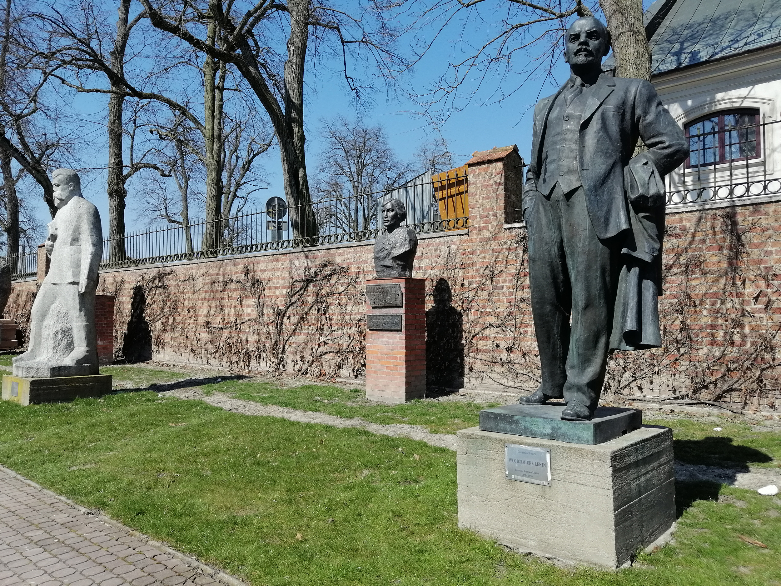 Fotografia. Pomnik Włodzimierza Lenina, postać całościowa. Rzeźba z brązu o wymiarach 260 x 120 x 75 cm ustawiona na betonowym postumencie z metalową tabliczką. Na tabliczce napis: Dimitri Schwarz, Włodzimierz Lenin, Poronin, Muzeum Lenina 1950-1990